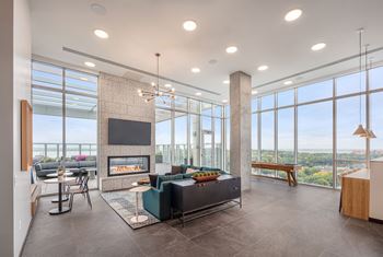 A modern living room with a fireplace and a view of the city.
